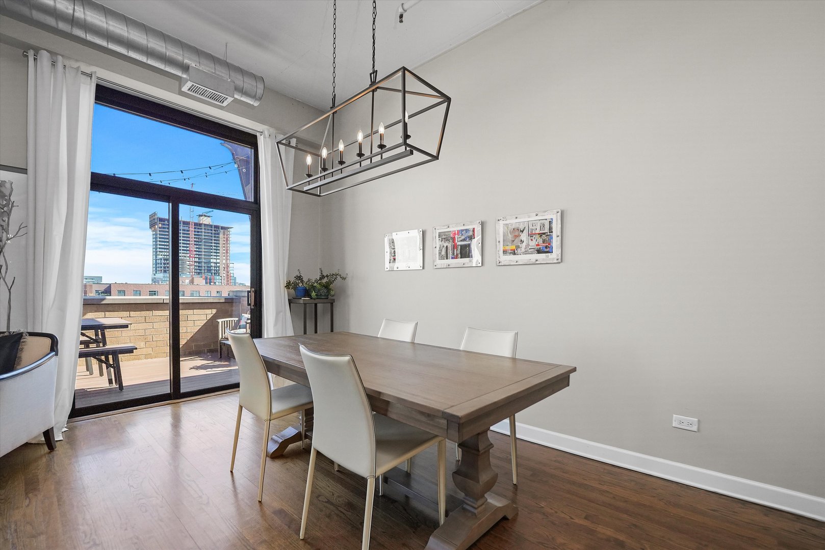 1301 West Madison Street, Unit 629 Chicago, IL 60607 - Photo 7 of 25 a view of a dining room with furniture window and wooden floor