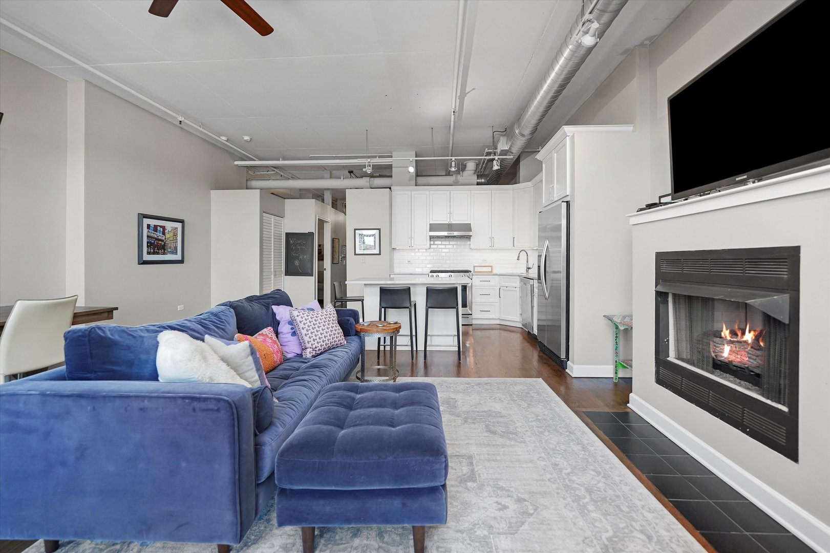 1301 West Madison Street, Unit 629 Chicago, IL 60607 - Photo 8 of 25 a living room with furniture and a fireplace