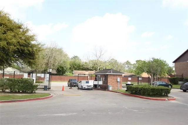 a front view of a house with a garden and houses