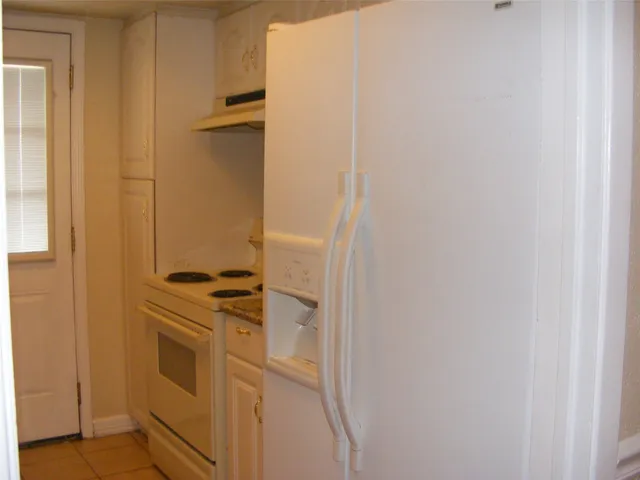 a kitchen with a stove and a refrigerator