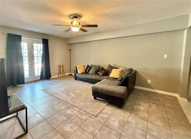 a living room with furniture and a chandelier