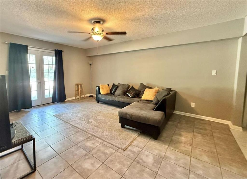 125 Rue Fontaine Lithonia, GA 30038 - Photo 4 of 6 a living room with furniture and a chandelier