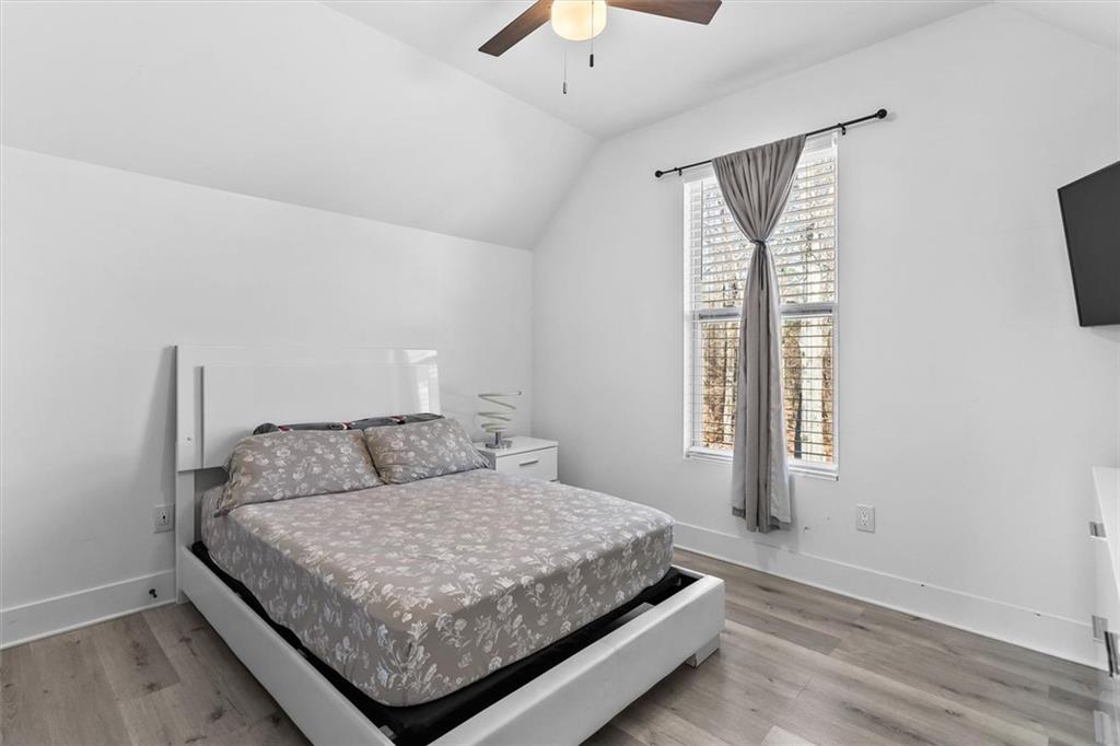 658 Rockbridge Road Northwest Lilburn, GA 30047 - Photo 8 of 61 a bedroom with a bed and window