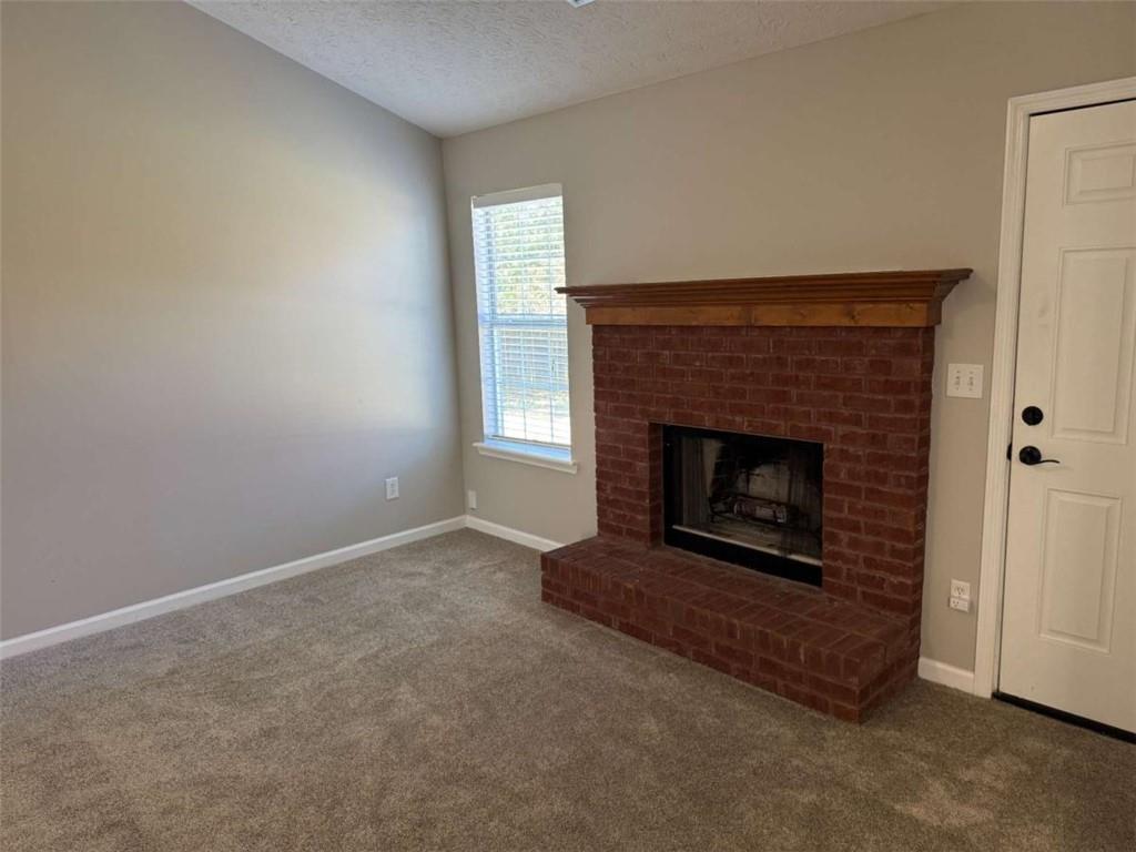 1672 Walters Park Court Loganville, GA 30052 - Photo 17 of 35 a living room with a fireplace