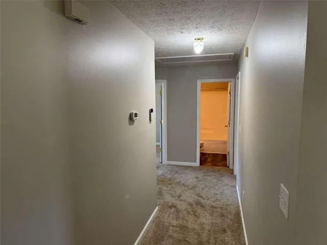 a view of a hallway with wooden shelves