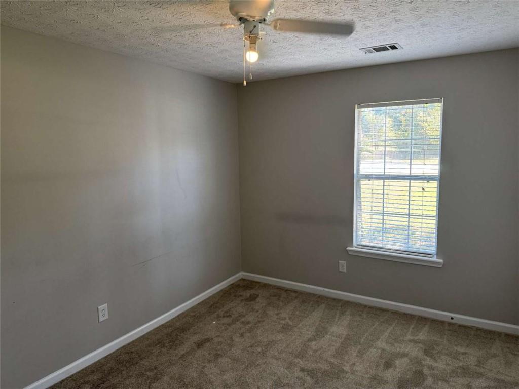 1672 Walters Park Court Loganville, GA 30052 - Photo 22 of 35 an empty room with a window