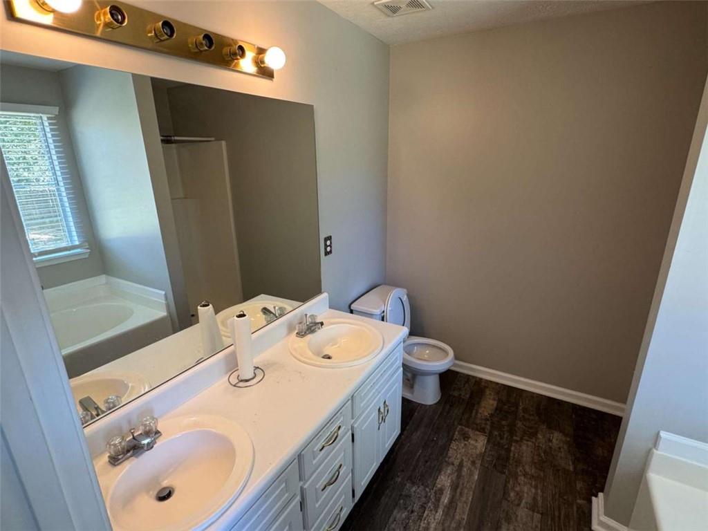 1672 Walters Park Court Loganville, GA 30052 - Photo 30 of 35 a bathroom with a sink a toilet and shower