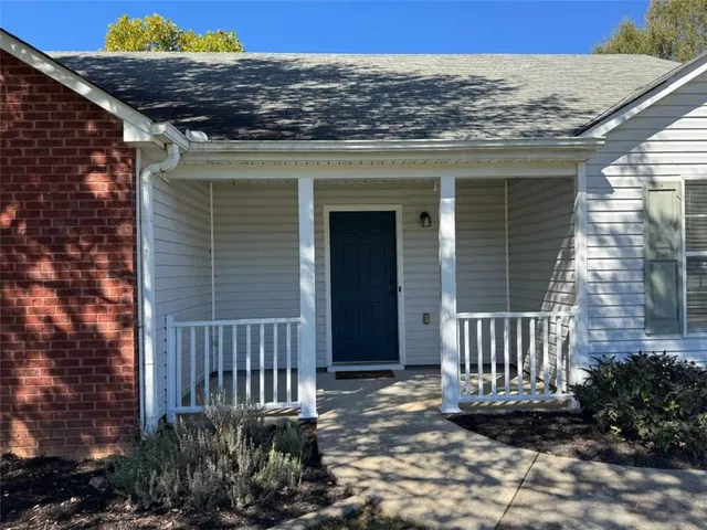 a view of a house with a yard and wooden floor