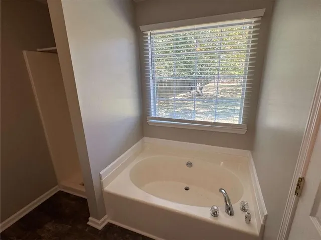 a bathroom with a tub and shower