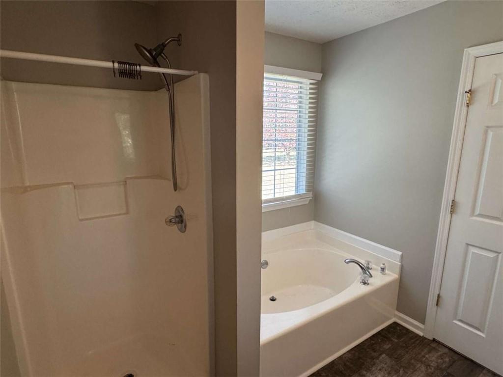 1672 Walters Park Court Loganville, GA 30052 - Photo 32 of 35 a bathroom with a tub and shower