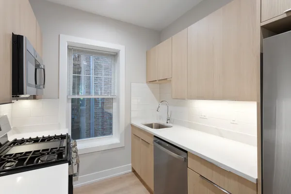 a kitchen with a sink stove and cabinets