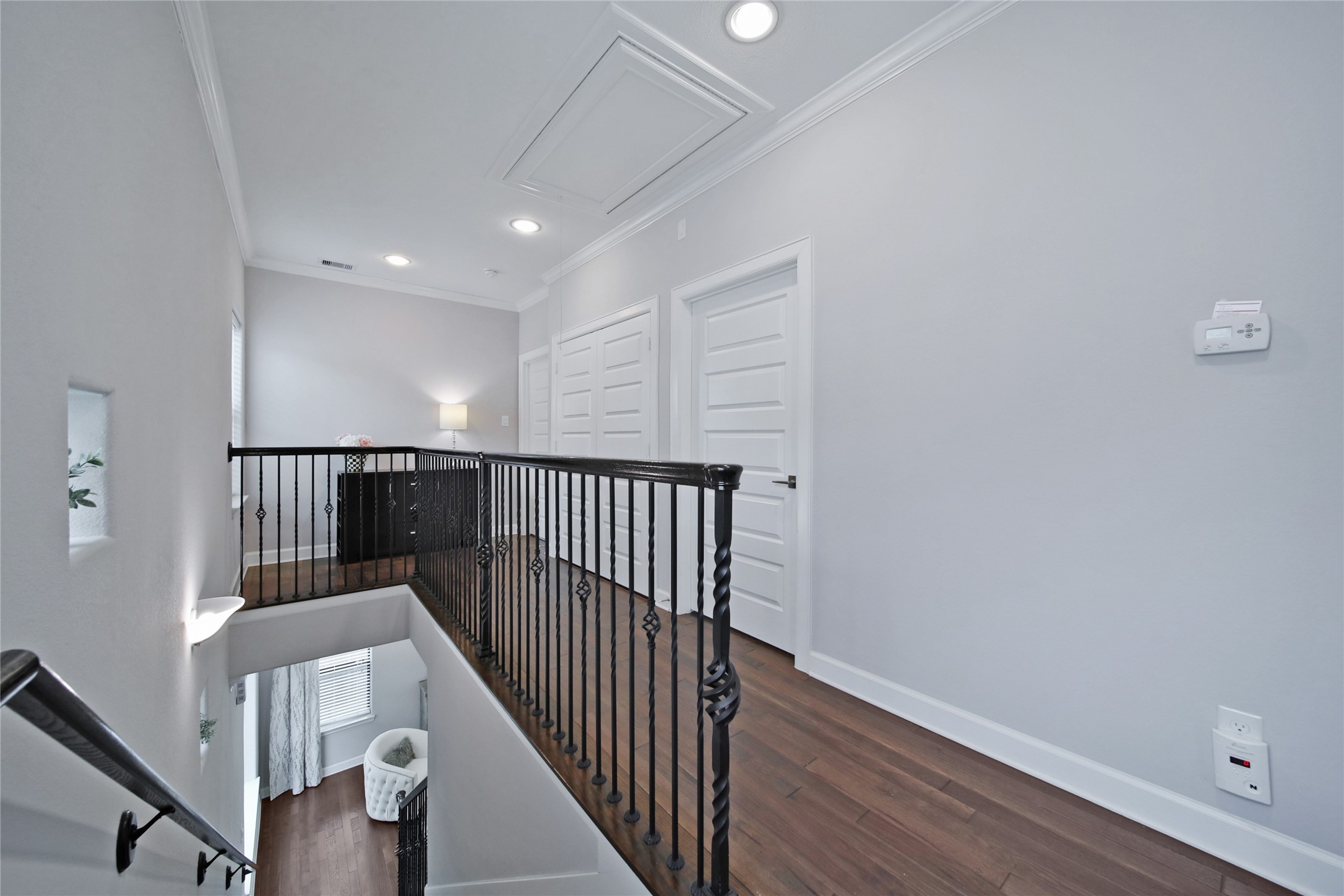 5703 Kansas Street Houston, TX 77007 - Photo 15 of 20 a view of a hallway with wooden floor and stairs