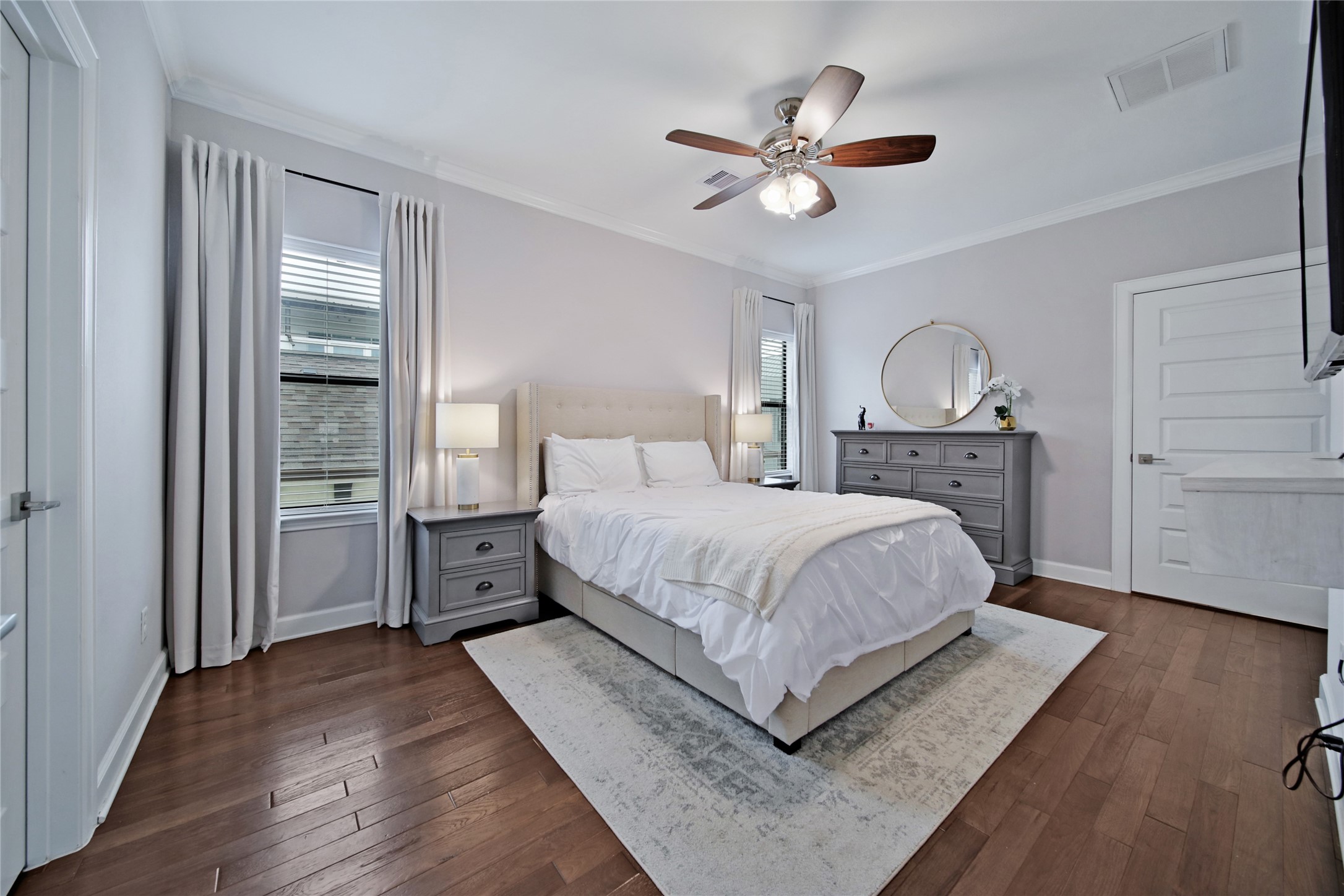 5703 Kansas Street Houston, TX 77007 - Photo 16 of 20 a bed room with a bed and a chandelier