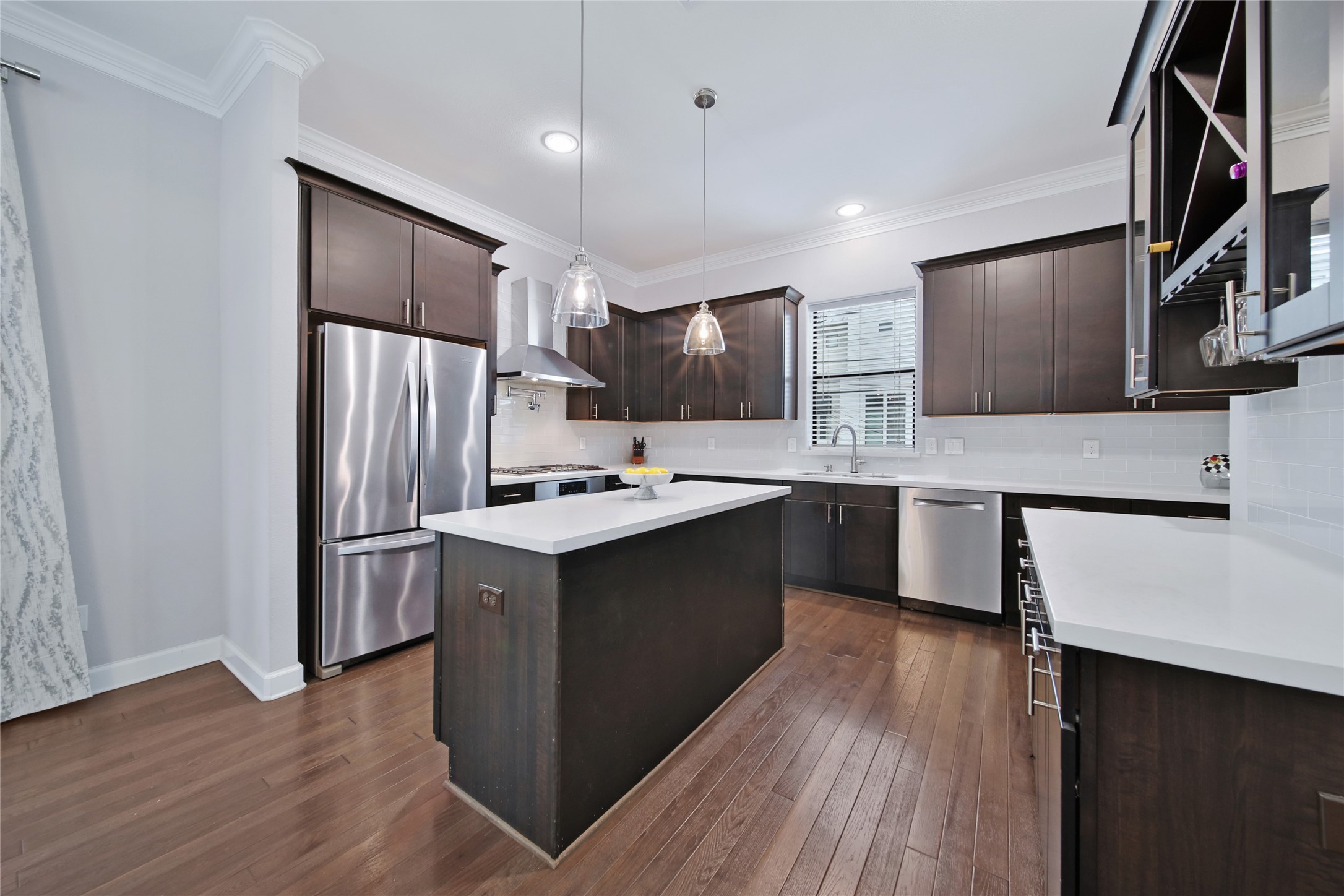 5703 Kansas Street Houston, TX 77007 - Photo 8 of 20 a kitchen with stainless steel appliances kitchen island a sink stove and refrigerator