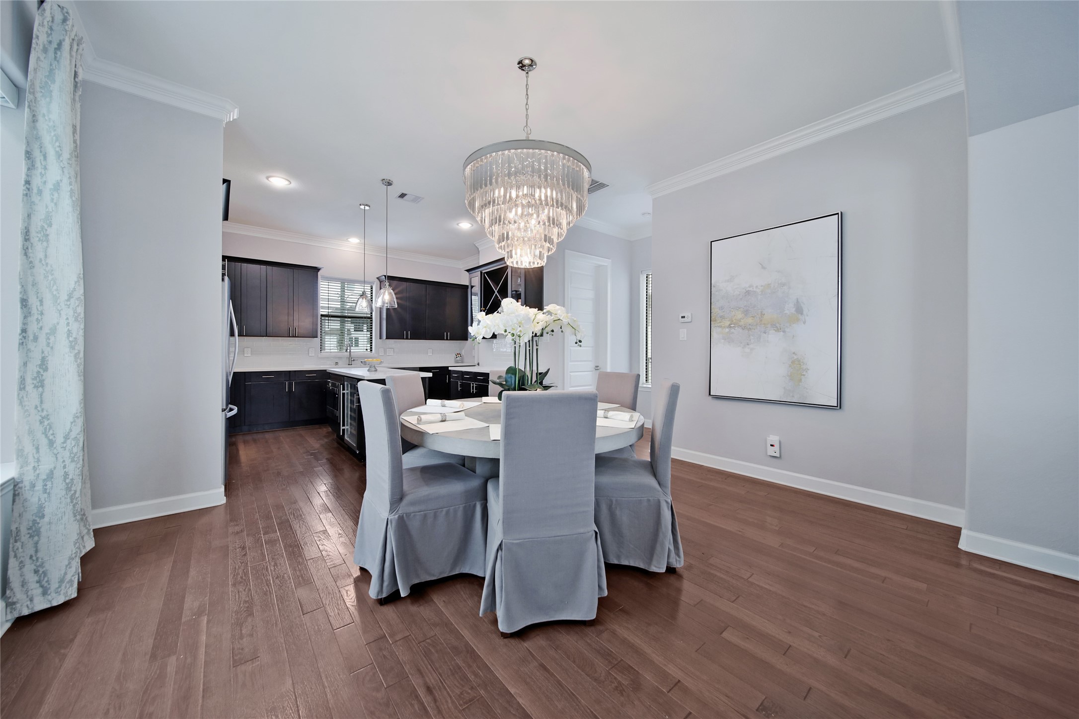 5703 Kansas Street Houston, TX 77007 - Photo 9 of 20 a dining room with furniture a chandelier and wooden floor