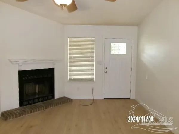 a view of an empty room with a fireplace