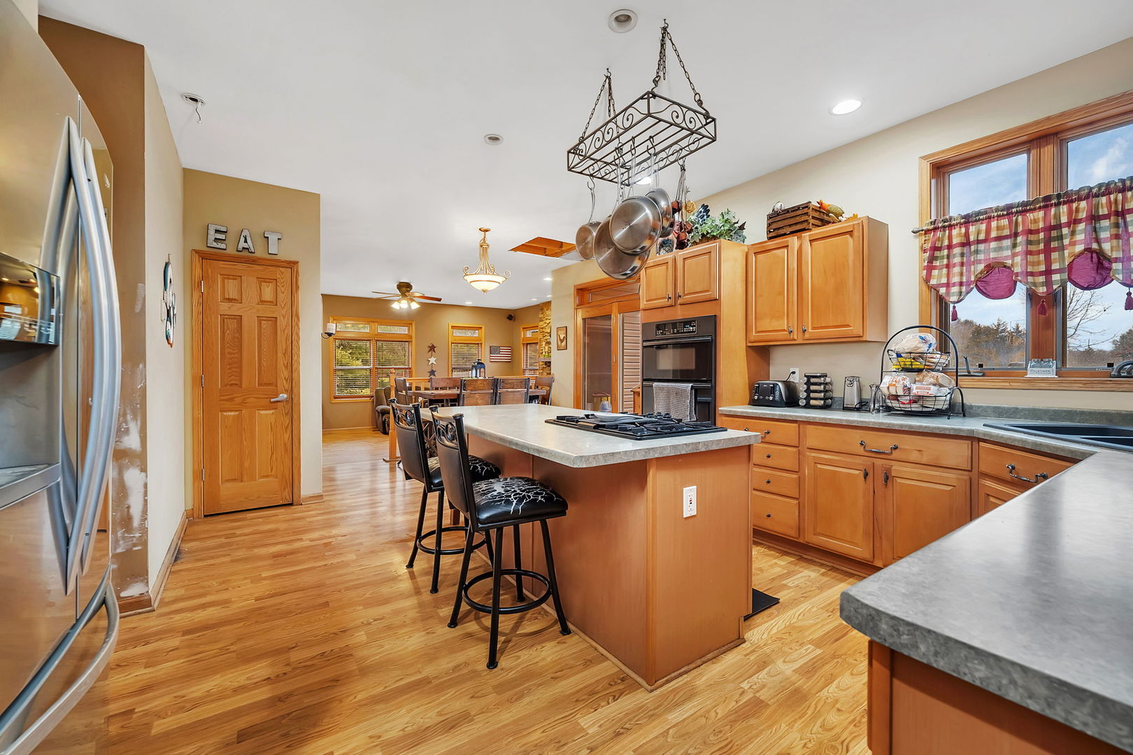 36963 Irish Lane Custer Park, IL 60481 - Photo 5 of 49 a kitchen with stainless steel appliances granite countertop a sink a stove and a wooden floors