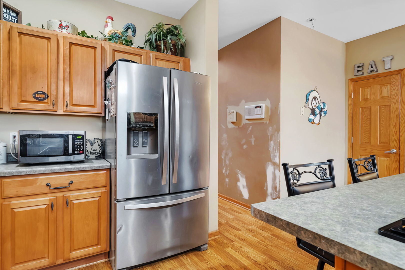 36963 Irish Lane Custer Park, IL 60481 - Photo 9 of 49 a kitchen with stainless steel appliances granite countertop a refrigerator a stove and a sink with wooden floor