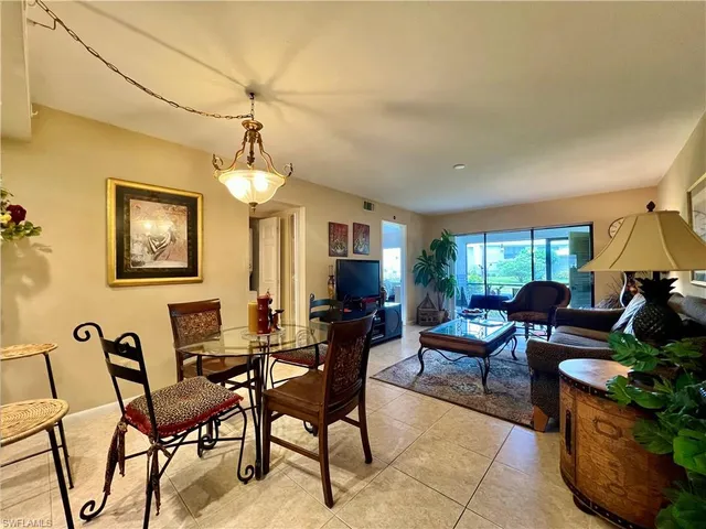 a living room with furniture a window and gym equipment