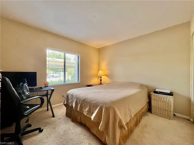 a bedroom with a bed and chair