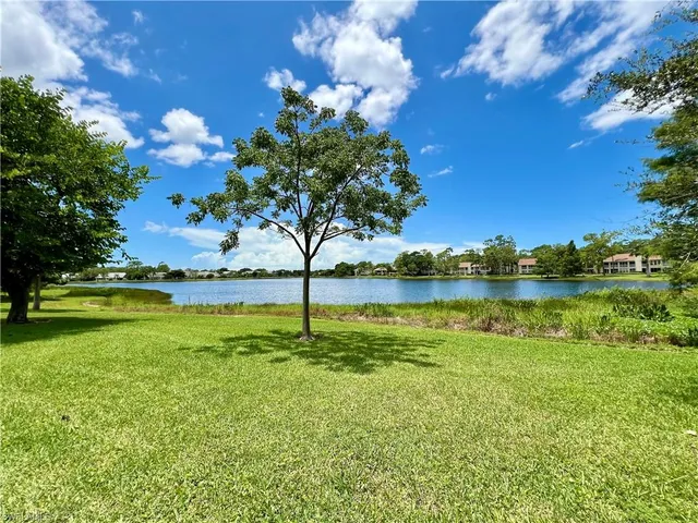 a view of a lake and houses in the back
