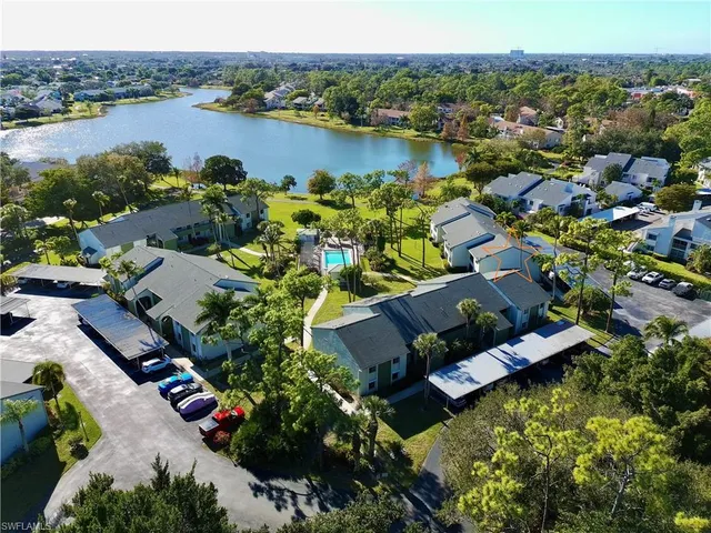 an aerial view of lake residential house with outdoor space and mountain view