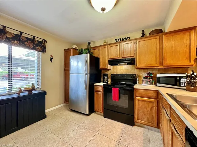 a kitchen with a refrigerator and a sink