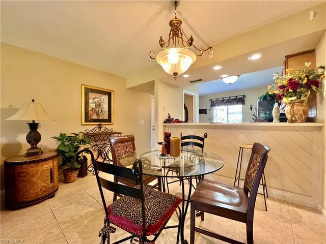 a view of a dining room with furniture and a chandelier