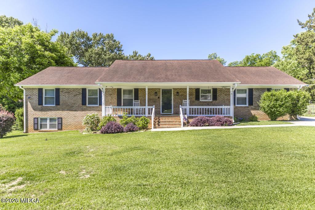 3710 Sandy Circle Macon, GA 31216 - Photo 1 of 44 a front view of a house with a garden and porch
