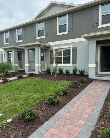 a front view of a house with garden and porch