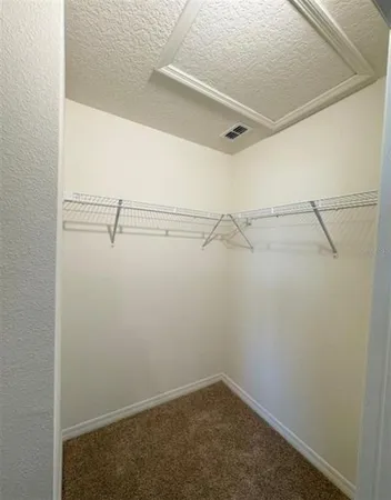 a bathroom with a granite countertop sink a mirror and shower