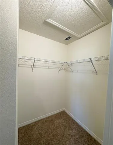 a bathroom with a granite countertop sink a mirror and shower