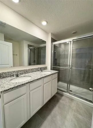 a white toilet sitting next to a shower