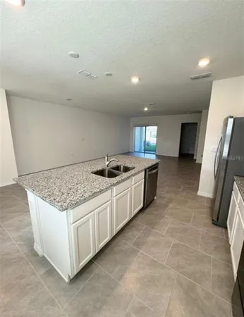 a kitchen with a sink and a stove top oven
