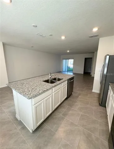 a kitchen with a sink and a stove top oven