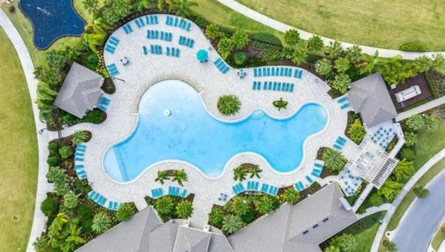 an aerial view of a house with swimming pool outdoor seating and yard