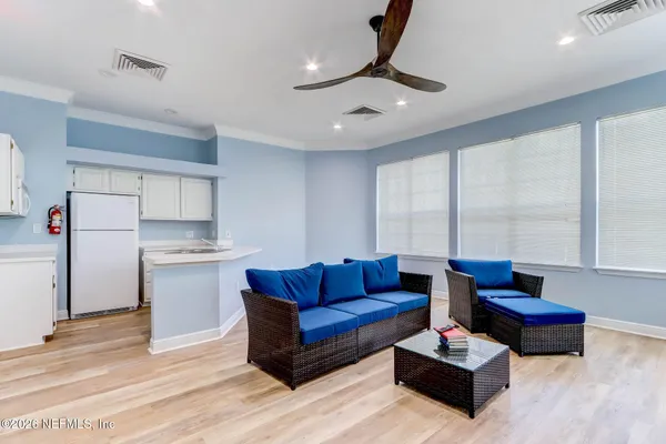 a living room with furniture gym equipment and a large window