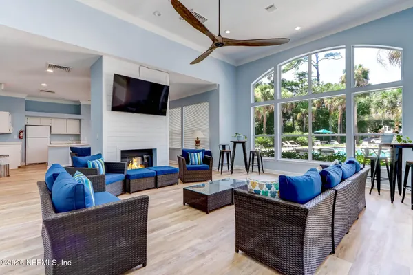 a view of backyard with swimming pool and outdoor seating