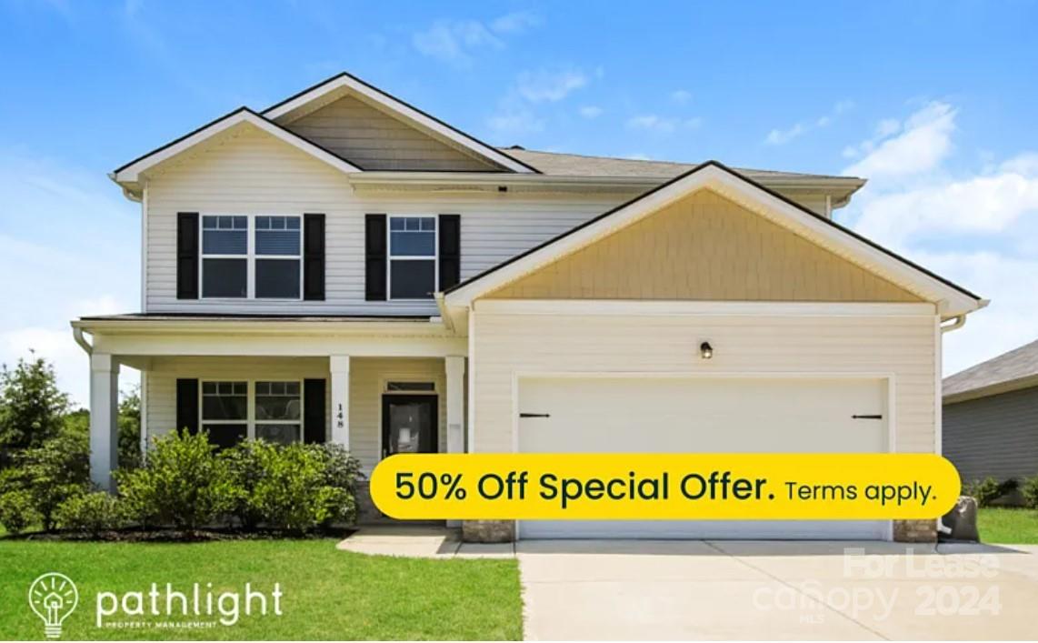 a view of a house with a yard and front a house