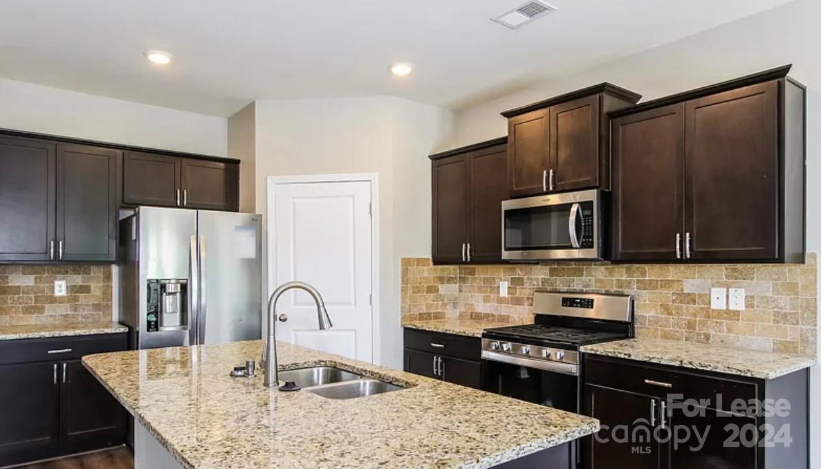 148 Lookout Loop North Augusta, SC 29841 - Photo 5 of 14 a kitchen with stainless steel appliances granite countertop a refrigerator a stove top oven a sink and cabinets