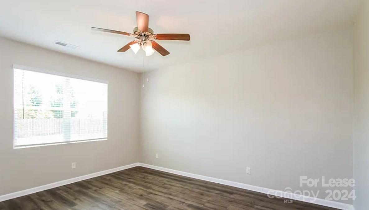 148 Lookout Loop North Augusta, SC 29841 - Photo 6 of 14 an empty room with wooden floor fan and windows