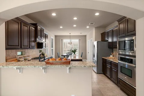 a kitchen with stainless steel appliances granite countertop a refrigerator and a sink