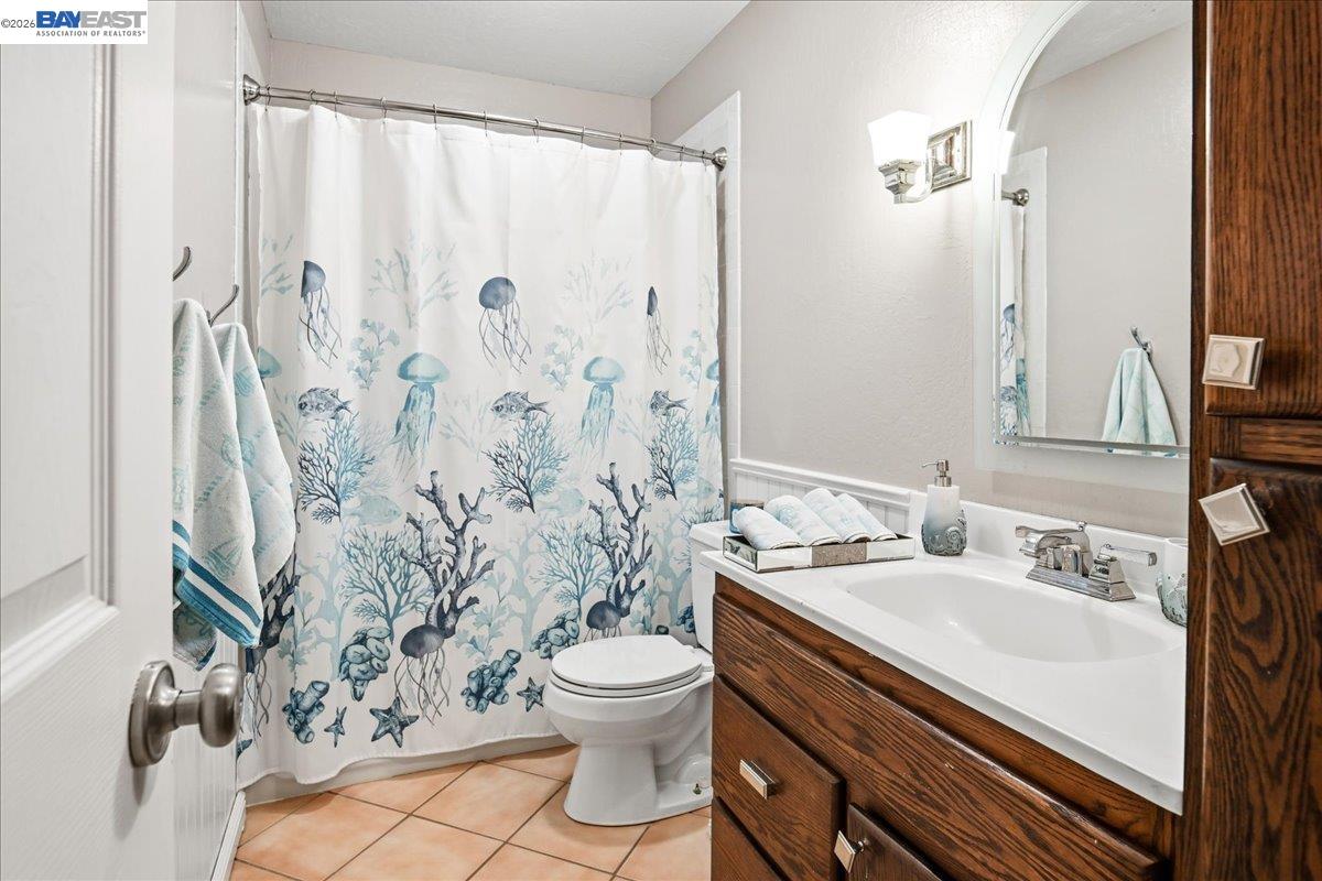 2861 Millbridge Place San Ramon, CA 94583 - Photo 39 of 58 a bathroom with a sink toilet a mirror and shower