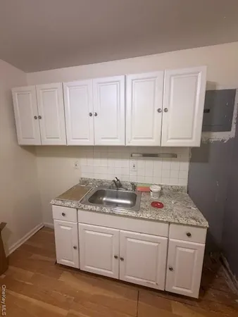 a kitchen with stainless steel appliances granite countertop white cabinets sink and dishwasher