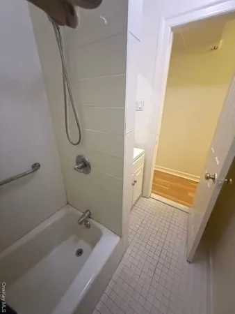 a bathroom with a tub sink and shower