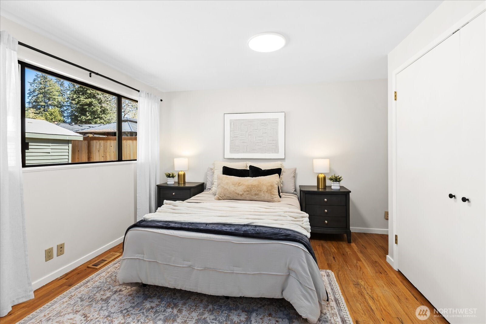 10601 242nd Place Southwest Edmonds, WA 98020 - Photo 17 of 35 a bedroom with a bed and a large window