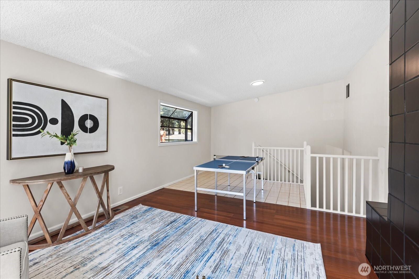 10601 242nd Place Southwest Edmonds, WA 98020 - Photo 24 of 35 a living room with wooden floor and a table