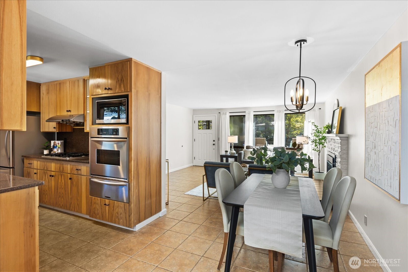 10601 242nd Place Southwest Edmonds, WA 98020 - Photo 9 of 35 a kitchen with refrigerator a dining table and chairs