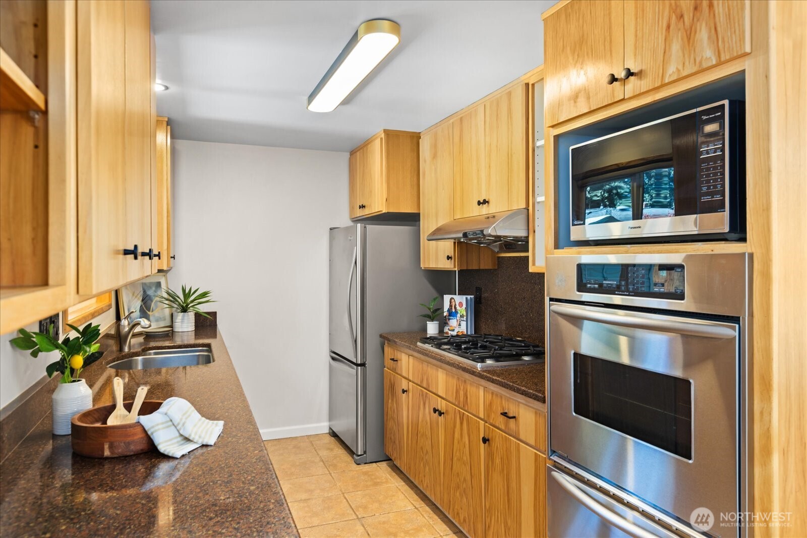10601 242nd Place Southwest Edmonds, WA 98020 - Photo 10 of 35 a kitchen with stainless steel appliances a stove microwave and refrigerator