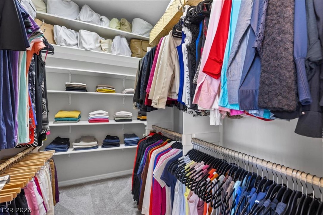 10334 Mopan Road Las Vegas, NV 89178 - Photo 18 of 28 The primary walk-in closet includes built in shelving and ample hanging storage.